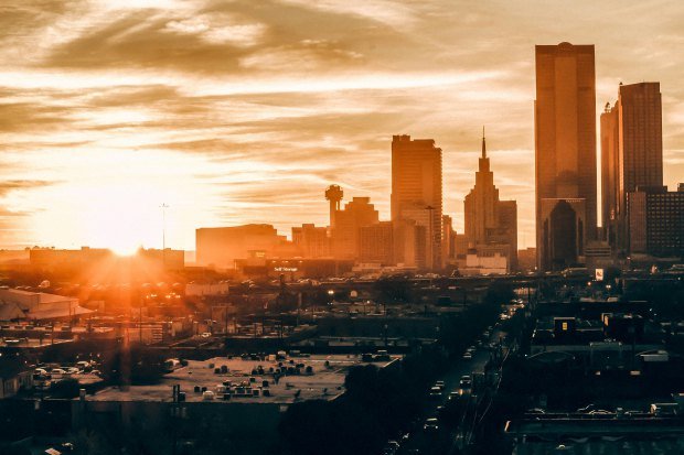 Stunning Dallas skyline at sunset, showcasing vibrant colors and iconic architecture.